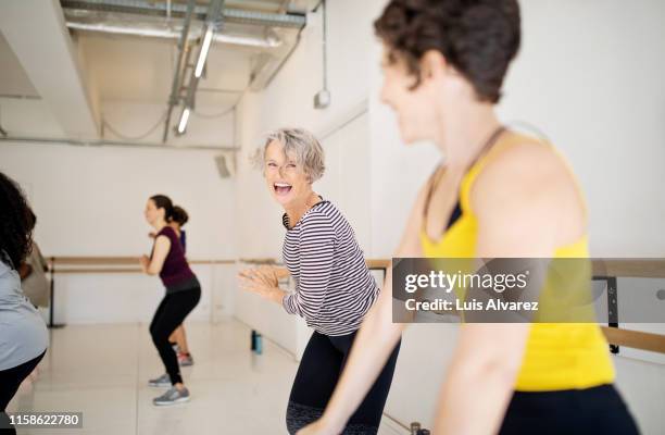 women enjoying a dance routine in fitness studio - dance studio fotografías e imágenes de stock