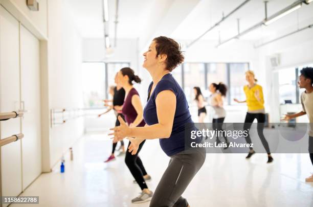 multi-ethnic females dancing in health club - voluptueus stockfoto's en -beelden