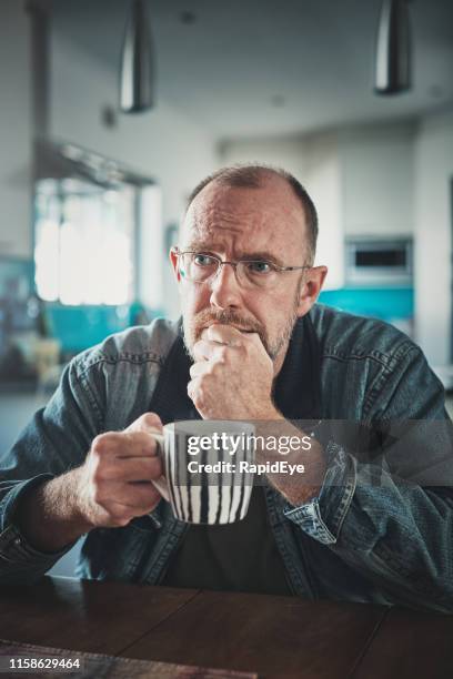 troubled middle-aged man looks up in despair - nail biting stock pictures, royalty-free photos & images
