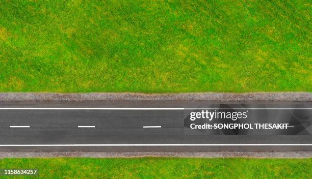 the road in the middle of the field./aerial shot - top fotografías e imágenes de stock