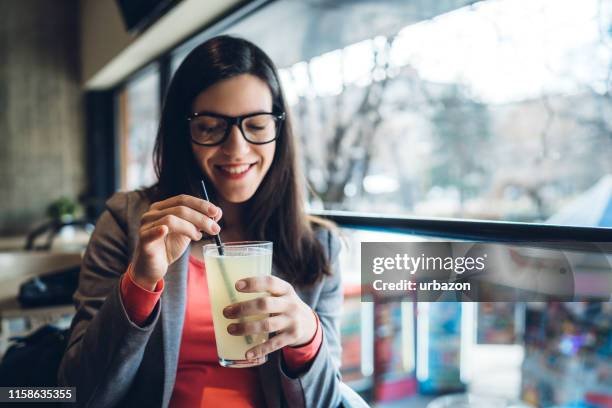 drinking lemonade in cafe - lemon juice stock pictures, royalty-free photos & images