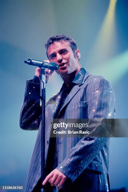 Scottish singer Marti Pellow performs live on stage with pop group Wet Wet Wet during a concert at Wembley Arena in London on 6th December 1995.