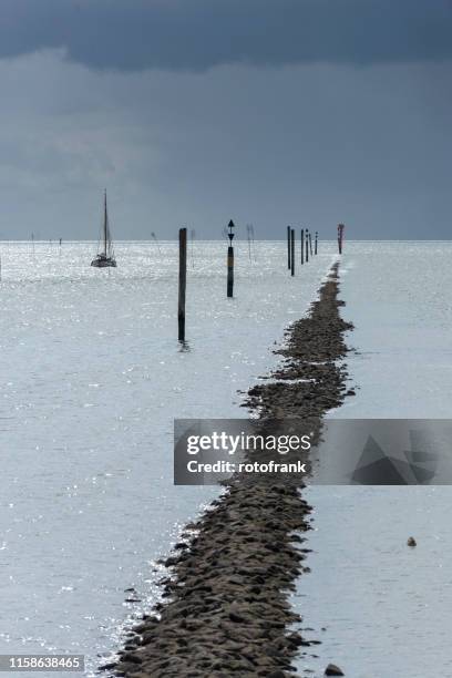 germany, lower saxony, east frisia, juist, bune at the port exit. - begrenzung stock pictures, royalty-free photos & images