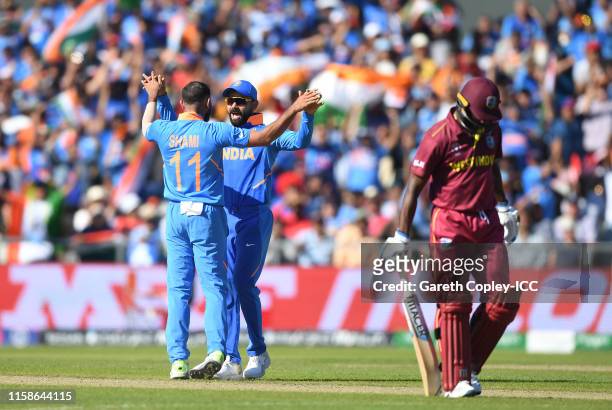 Mohammed Shami of India celebrates after taking the wicket of Shimron Hetmyer of West Indies with Virat Kohli of India during the Group Stage match...
