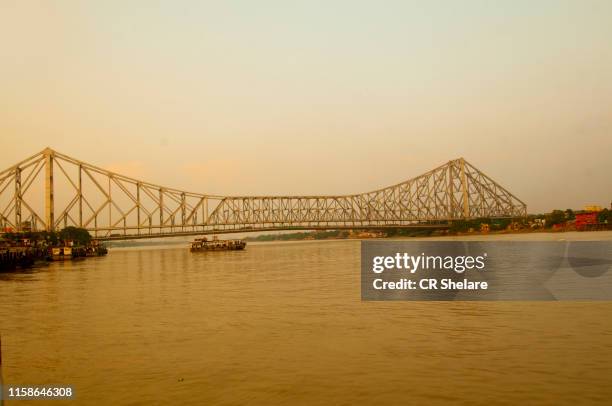 howrah bridge at sunset, kolkata, india. - howrah bridge stock pictures, royalty-free photos & images