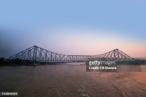 howrah bridge at sunset, kolkata, india. - howrah bridge stock pictures, royalty-free photos & images