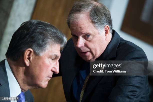 Sen. Doug Jones, D-Ala., right, and Joe Manchin, D-W.Va., are seen during the Senate Armed Services Committee confirmation hearing for Air Force Gen....