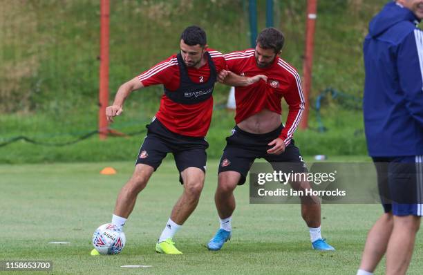 Conor Mclauglin holds off Will Grigg during a Sunderland AFC training session at The Academy of Light on July 30, 2019 in Sunderland, England.