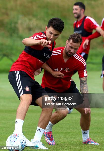 Luke O'Nien holds off Chris Maguire during a Sunderland AFC training session at The Academy of Light on July 30, 2019 in Sunderland, England.