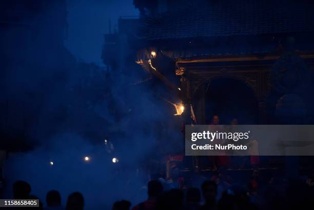 Nepalese devotees glance burning effigy of demon Ghantakarna during the Ghantakarna or Gathemangal festival celebrated at Bhaktapur, Nepal on...