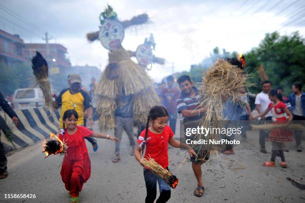 Nepalese devotees carrying burning straw to burn effigy demon Ghantakarna during the Gathemangal festival celebrated at Bhaktapur, Nepal on...