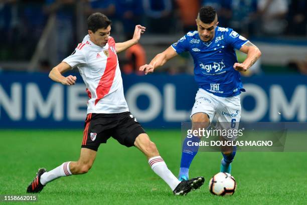 Egidio of Brazil's Cruzeiro is marked by Gonzalo Montiel of Argentina's River Plate during their Copa Libertadores football match at Mineirao Stadium...