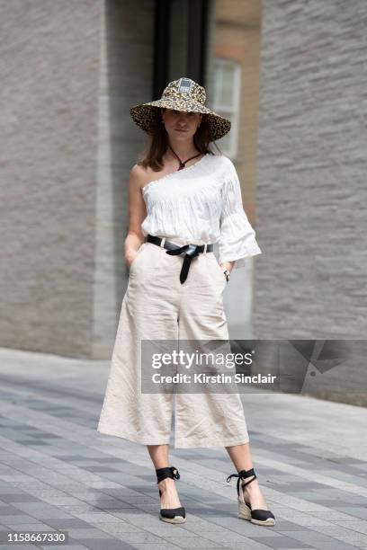 Fashion journalist and art historian Alexandra Spiegel wears a Ganni hat, Vince top, Isabel Marant belt, Uniqlo trousers and Castaner shoes during...