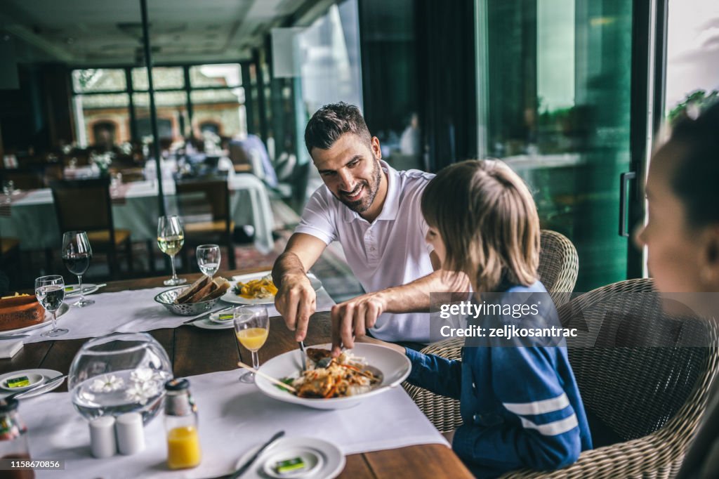Portrait of happy family eating in the restaurant