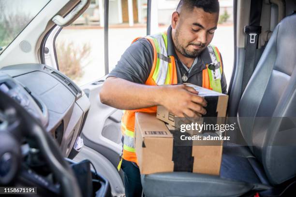 delivery man taking packages from vehicle - tradesman van stock pictures, royalty-free photos & images