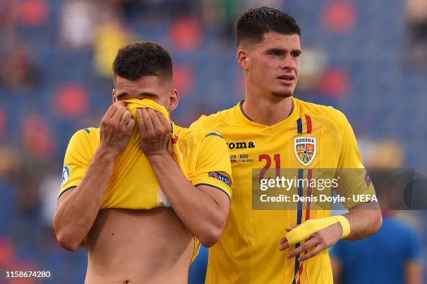 Ianis Hagi of Romania and Tudor Baluta of Romania show their dejection at the end of the 2019 UEFA U-21 Semi-Final match between Germany and Romania...