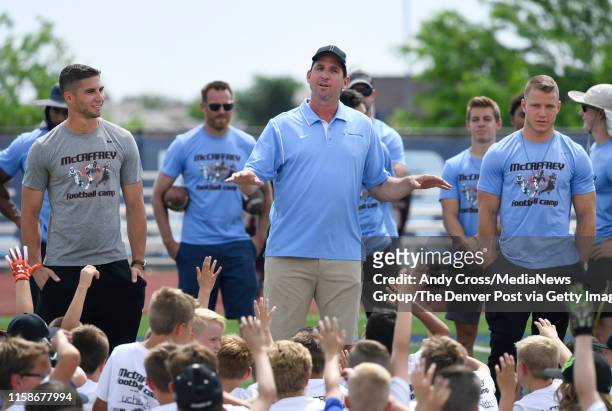 Former Denver Broncos WR Ed McCaffrey, center, talks to young football players filmed by his two sons, San Francisco 49ers "nWR, Max McCaffrey, left,...