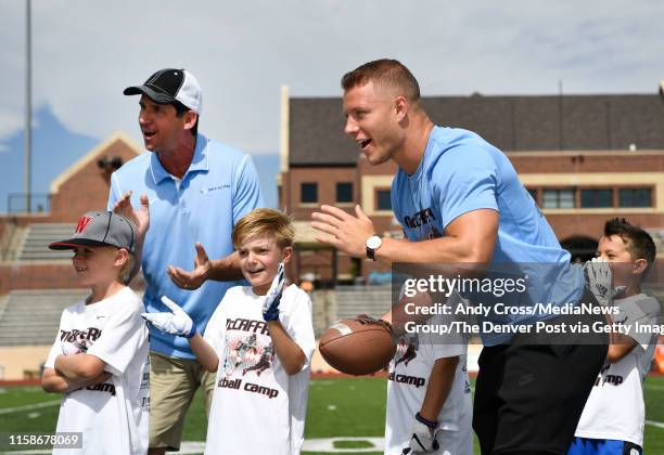 Ed McCaffrey, top left, and his son, Carolina Panthers RB, Christian McCaffrey, right, and campers encourage young football players at the McCaffrey...