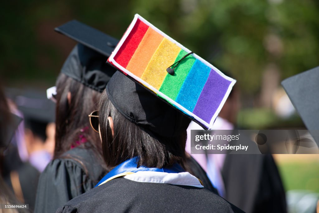 Woman Wears Graduation Cap and Gown Showing Gay Pride