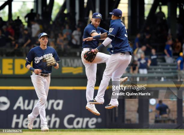 Christian Yelich, Ryan Braun and Orlando Arcia of the Milwaukee Brewers celebrate the 4-2 win against the Seattle Mariners at Miller Park on June 27,...