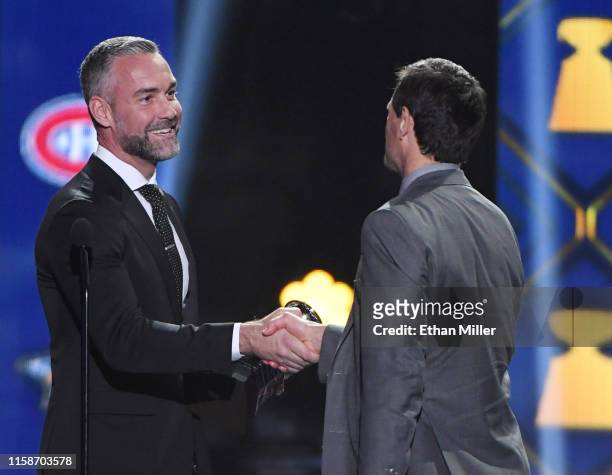 Actor Jay Harrington presents general manager Don Sweeney of the Boston Bruins with the General Manager of the Year Award during the 2019 NHL Awards...