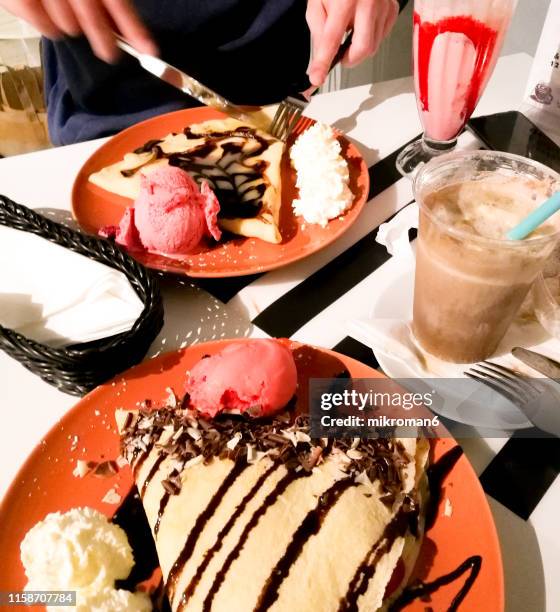 romantic dessert in a restaurant with crapes and ice cream and coffee - nutella pancake stock pictures, royalty-free photos & images