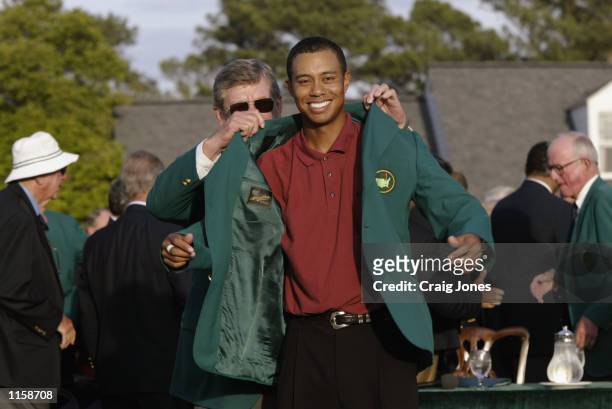 Tiger Woods of the USA is presented with his green jacket by Chairman of Augusta National Hootie Johnson after winning the Masters Tournament at the...