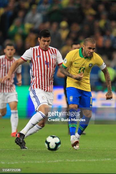 Fabian Balbuena of Paraguay fights for the ball with Dani Alves of Brazil during the Copa America Brazil 2019 quarterfinal match between Brazil and...