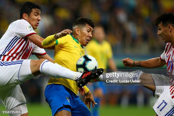 Fabian Balbuena and Hernan Perez of Paraguay fights for the ball with Roberto Firmino of Brazil during the Copa America Brazil 2019 quarterfinal...