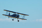 biplane Stearman Kadet flying in sky