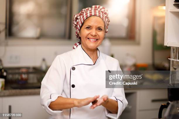 confectioner preparing chocolate sweet - brigadeiro - confectioner stock pictures, royalty-free photos & images