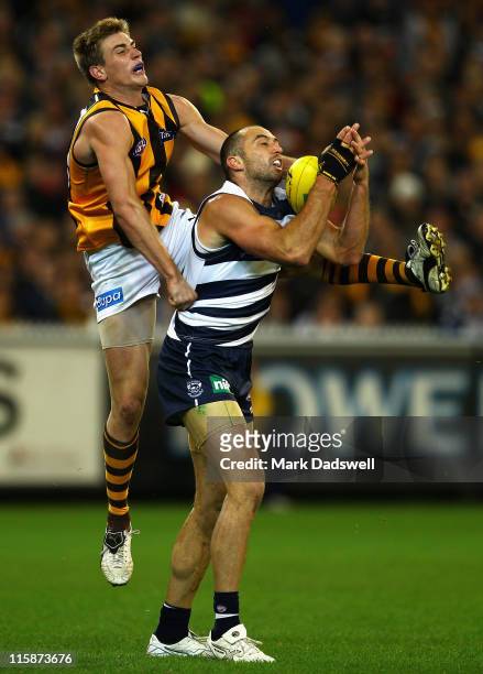 James Podsiadly of the Cats marks in front of Ryan Schoenmakers of the Hawks during the round 12 AFL match between the Geelong Cats and the Hawthorn...