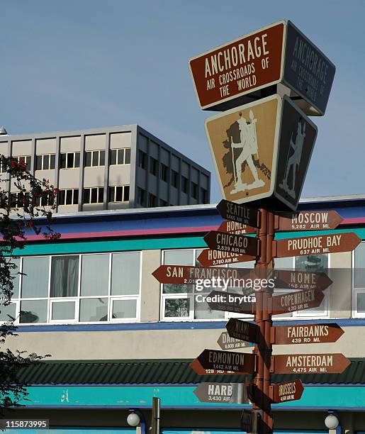 signpostwith distances and directions in anchorage,alaska - anchorage alaska stock pictures, royalty-free photos & images