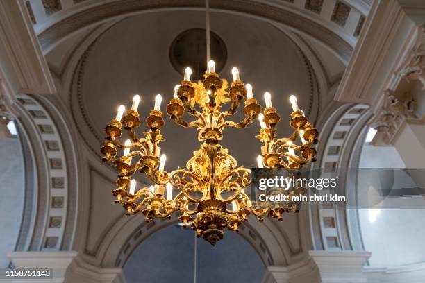 brass chandelier in helsinki church - chandelier stock pictures, royalty-free photos & images
