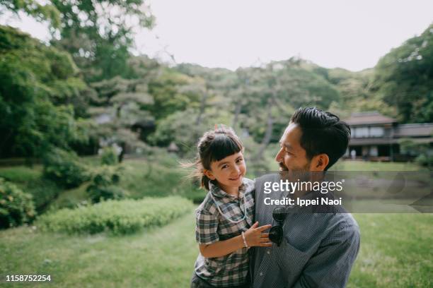 japanese father and 5 year old mixed race daughter smiling at camera - japanese family ストックフォトと画像