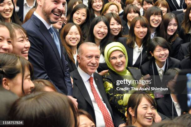 Turkish President Recep Tayyip Erdogan and his wife Emine Erdogan pose with students of Mukogawa Women's University after receiving the honorary...