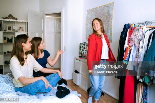 girls choosing clothes for the day - dress fitting room stock pictures, royalty-free photos & images