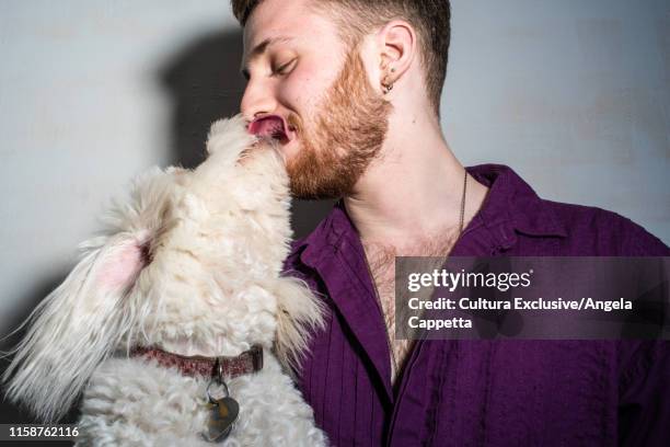 pet dog licking man's face - dog licking face stockfoto's en -beelden