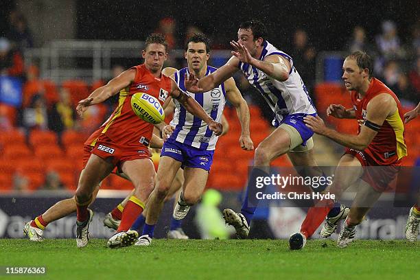 Daniel Harris of the Suns kicks the ball during the round 12 AFL match between the Gold Coast Suns and the North Melbourne Kangaroos at Metricon...