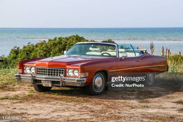 Red Cadillac Eldorado is seen during the every Monday retro cars owners meeting on the public beach in Hevringholm, Denmark on 29 July 2019