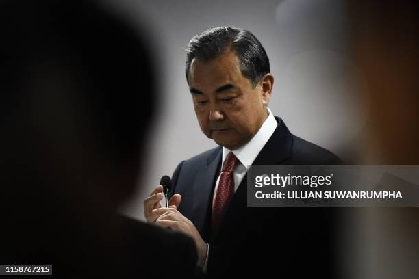 China's Foreign Minister Wang Yi prepares to speak at a press conference on the sidelines of the 52nd Association of Southeast Asian Nations Foreign...