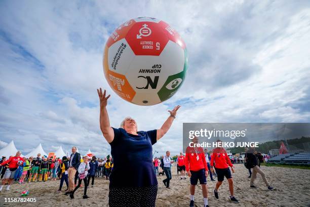 Norway's Prime Minister Erna Solberg plays with a giant football at the Norway Cup at Ekebergsletta in Oslo on July 31, 2019. - The ball is a symbol...