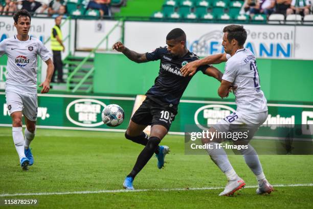 Daniel Keita-Ruel of SpVgg Greuther Fuerth and Robert Jendrusch of FC Erzgebirge Aue battle for the ball during the Second Bundesliga match between...