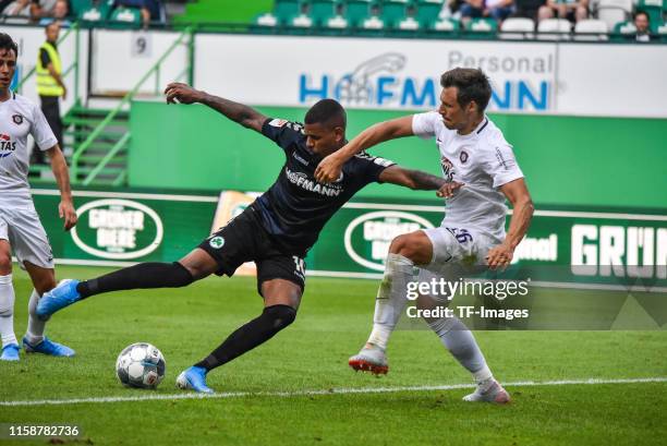 Daniel Keita-Ruel of SpVgg Greuther Fuerth and Robert Jendrusch of FC Erzgebirge Aue battle for the ball during the Second Bundesliga match between...