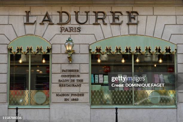 This picture taken on June 29, 2019 shows the facade of Laduree luxury cakes, pastries and macarons shop on the Champs Elysees avenue in Paris.