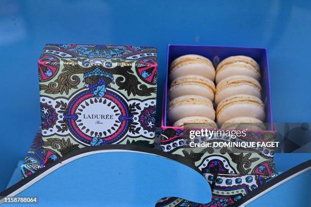 This picture taken on June 29, 2019 shows a box of Laduree macarons at the Champs Elysees avenue shop in Paris.