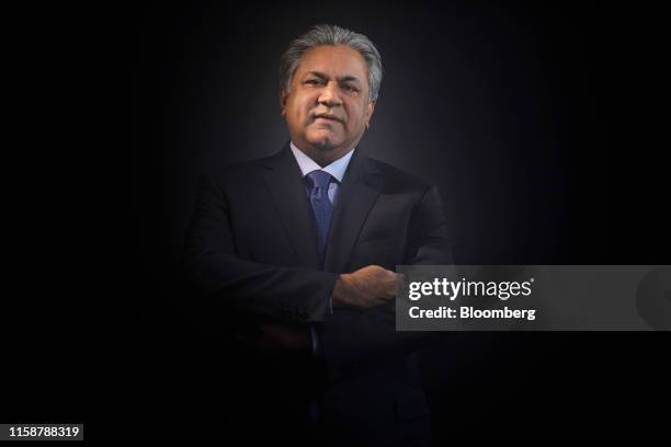 Arif Naqvi, chief executive officer of Abraaj Capital Ltd., poses for a photograph following a Bloomberg Television interview at the World Economic...