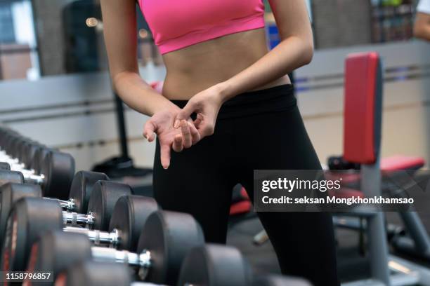 woman have accident injury and hurt at arms while workout and weight training at gym, muscle pain concept - wrist stock pictures, royalty-free photos & images
