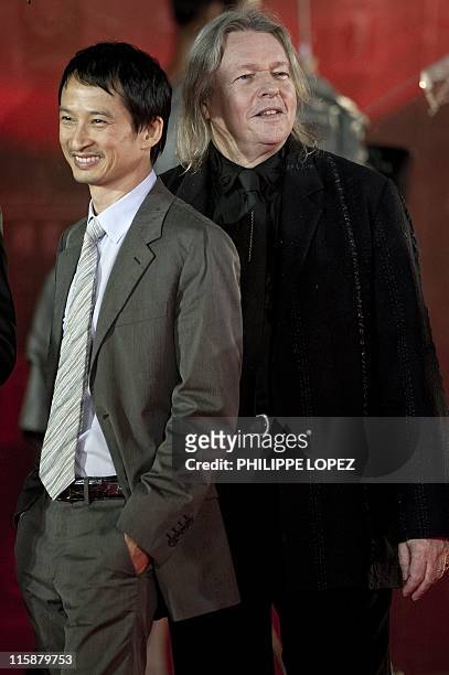Members of the jury French film director Tran Anh Hung and British film director Christopher James Hampton arrive on the red carpet during the...