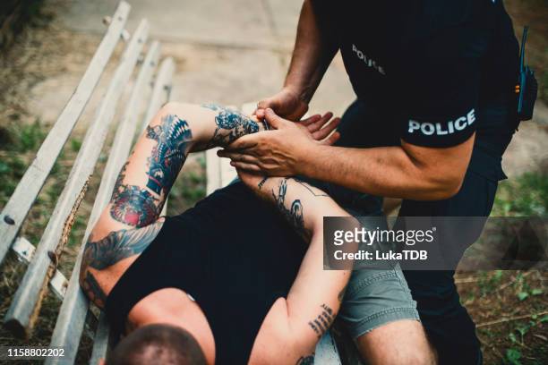 pointing to the criminal - gang arrest stock pictures, royalty-free photos & images